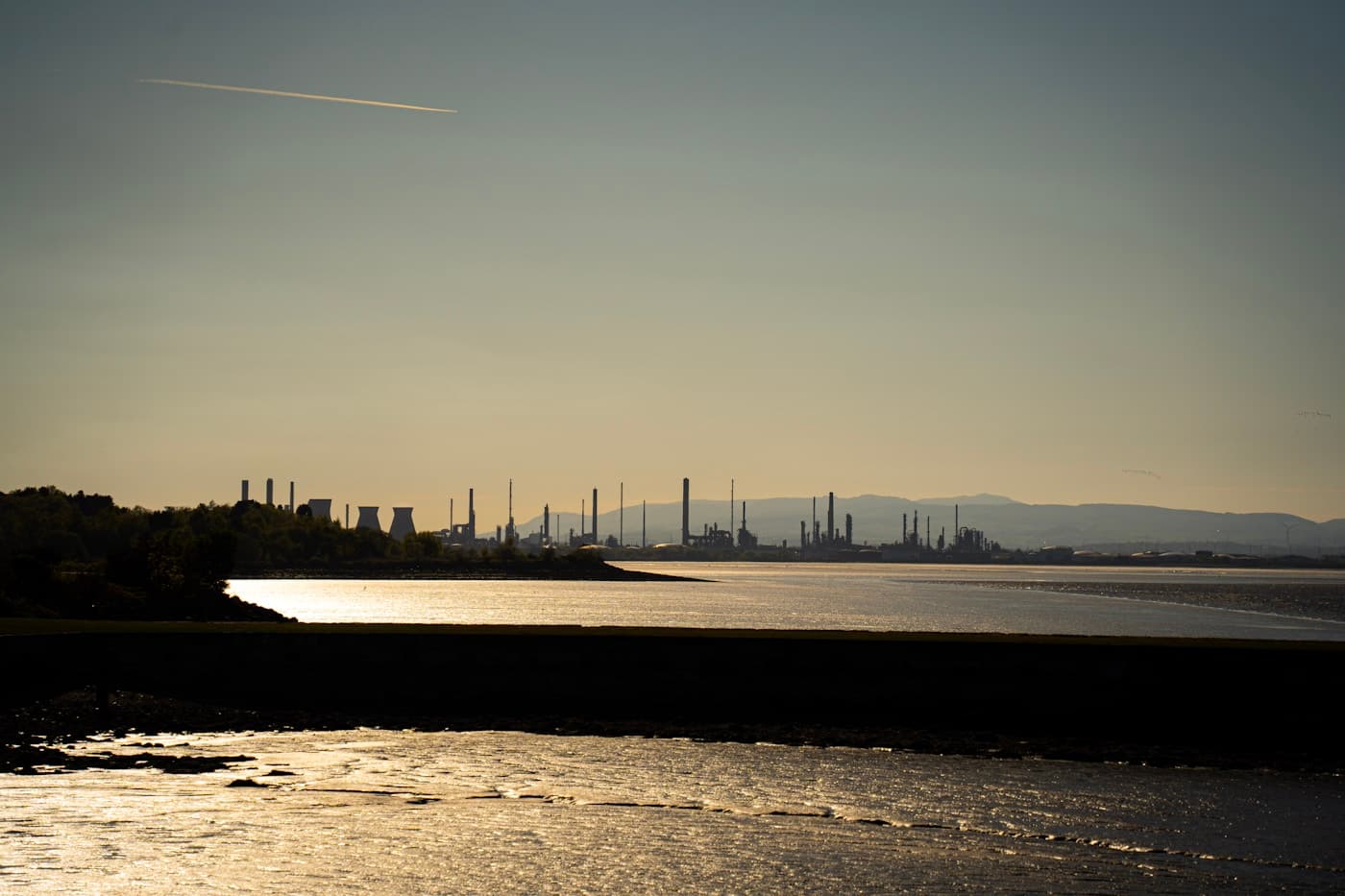 Oil refineries at sunset — energy sector