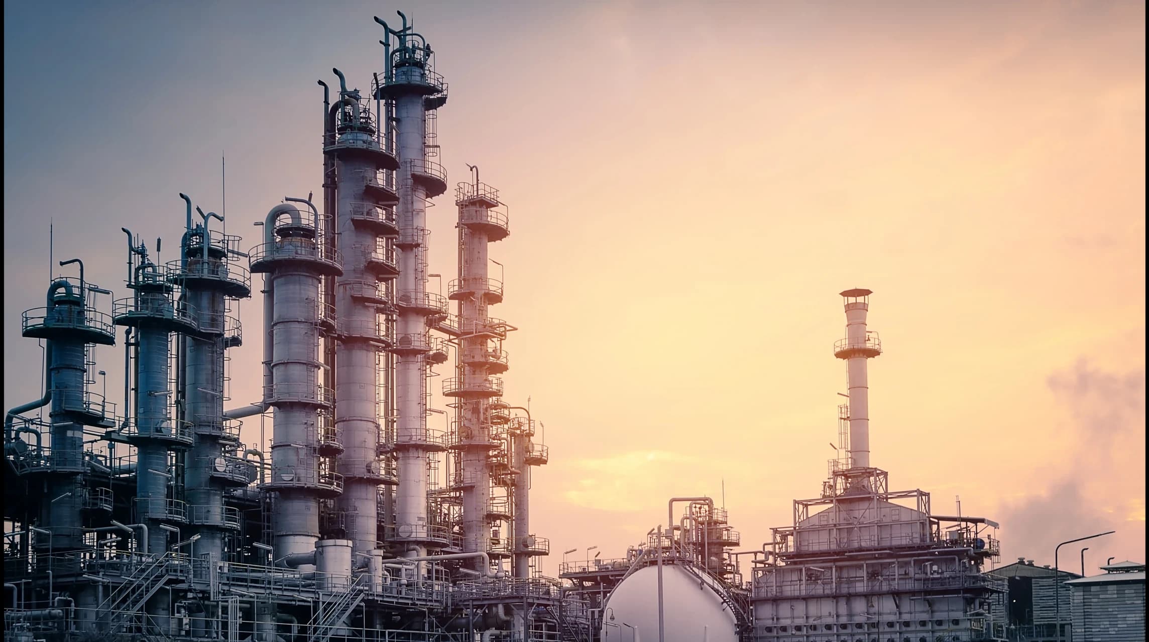 Oil refineries at sunset — energy sector